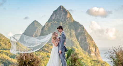 Bruidspaar tijdens een romantische trouwshoot met sluier en uitzicht op de iconische Pitons van St. Lucia. (c) Fotograaf Daniel